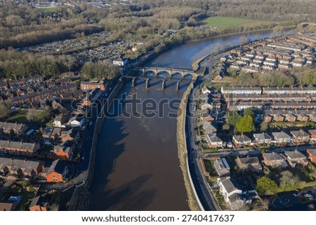 Aerial image of the dramatic River Ribble bend in Preston, featuring the Broadgate residential area, sports fields, and historic stone bridges.