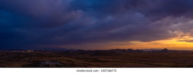 Aerial image of a dramatic sunset over the Sonoran Desert with homes and business below