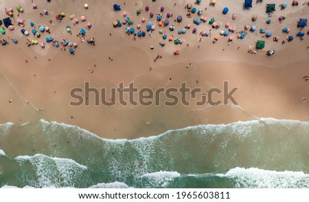 Similar – Luftaufnahme von fliegenden Drohnen von Menschen, die sich am Algarve Beach in Portugal entspannen.