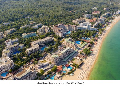 Aerial image a drone resort Golden Sands on Black Sea coast in Bulgaria. Many hotels and beaches with tourists, sunbeds and umbrellas. Sea travel destination. Travel and vacation concept - Shutterstock ID 1549073567