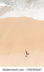 Aerial Image Of Fisherman Surf Casting On A Beach