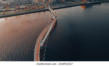 aerial image looking down onto the peace bridge in derry londonderry, northern ireland