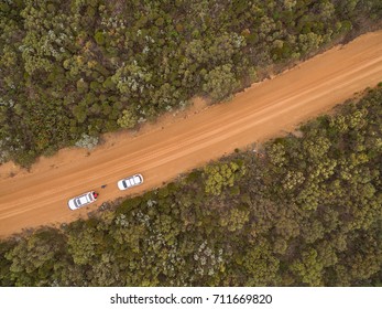 Aerial Image Of Red Dirt Road In Outback Australia With Two 4 Wheel Drives Parked Off-road