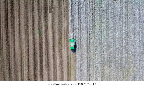 Aerial Image Of A Six Row Baler Cotton Picker Working In A Field.