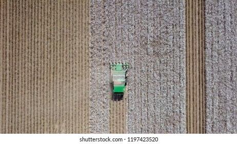 Aerial Image Of A Six Row Baler Cotton Picker Working In A Field.