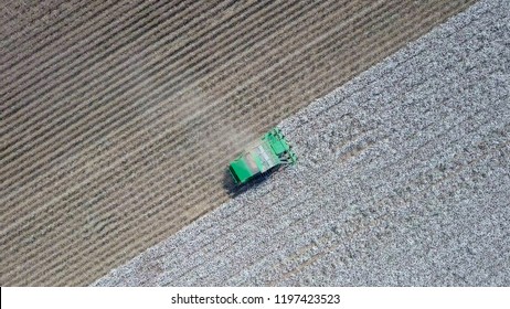 Aerial Image Of A Six Row Baler Cotton Picker Working In A Field.