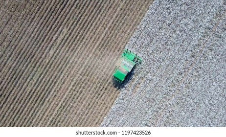 Aerial Image Of A Six Row Baler Cotton Picker Working In A Field.