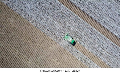 Aerial Image Of A Six Row Baler Cotton Picker Working In A Field.