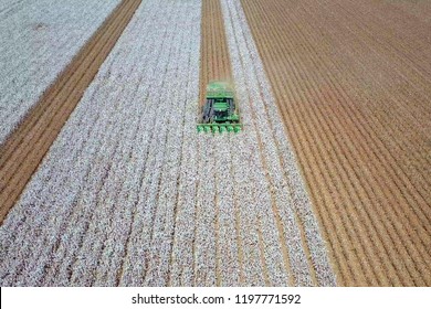 Aerial Image Of A Six Row Baler Cotton Picker Working In A Field.