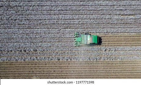 Aerial Image Of A Six Row Baler Cotton Picker Working In A Field.