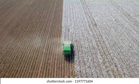 Aerial Image Of A Six Row Baler Cotton Picker Working In A Field.