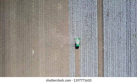 Aerial Image Of A Six Row Baler Cotton Picker Working In A Field.