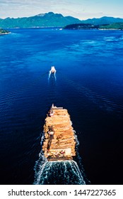 Aerial Image Of Tug Boat Towing Log Barge Off The Coast Of Vancouver Island, BC, Canada