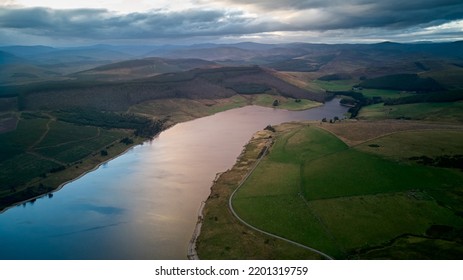 Aerial Image Of A Water Reservoir Taken In The Twilight With A Vibrant Sky.