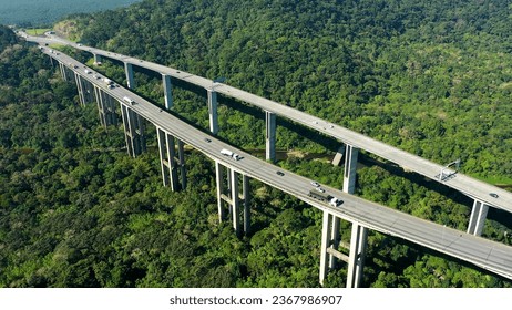 Aerial landscape of brazilian Imigrantes highway road at green forest trees and mountains. Traffic at road way to brazilian south coast. Legendary engineering construction. Brazil road landmark.