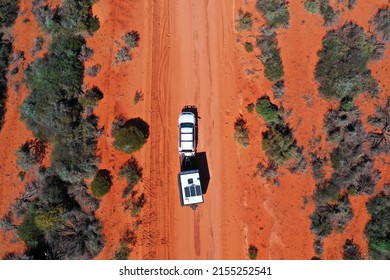 Aerial landscape drone view of 4WD vehicle towing an off road caravan driving on a sand dirt road during a road trip in Shark Bay Francois Peron National Park, Western Australia. No people. Copy space - Shutterstock ID 2155252541