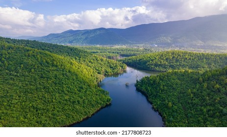 Aerial landscape with green hills, river and forest - Powered by Shutterstock