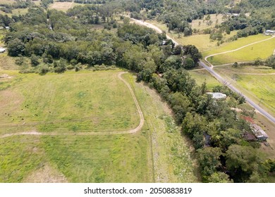 Aerial landscape over fields, bushland, homes and roads leading into a well known valley gorge, Finch Hatton, Queensland, Australia