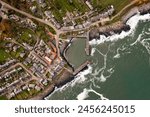 Aerial landscape panorama directly above the Northumberland fishing village of Craster which is famous for it