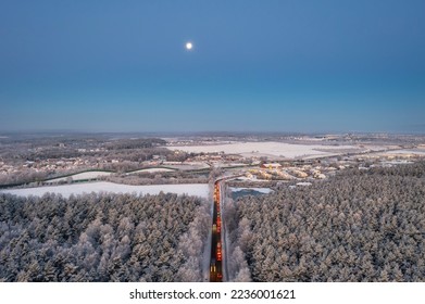 Aerial landscape of the road through snowy forest at winter, Poland.