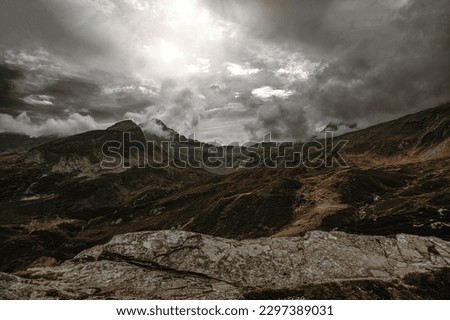 An aerial landscape of the rocky hill San Bernardino covered in dark clouds