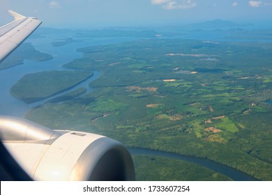 Aerial landscape view from airplane window of Krabi natural island and andaman sea in summer sunny day, Thailand. Famous travel destination in Southern of Thai. Focus at wing.