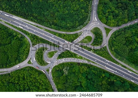 Similar – Image, Stock Photo Aerial view capturing the complex network of ridges and valleys in Utah’s desert, highlighted by contrasting golden paths