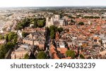 An aerial landscape view of a York cityscape skyline in North Yorkshire, UK with York Minster cathedral and the rooftop of historic buildings in the city centre with Summer sun