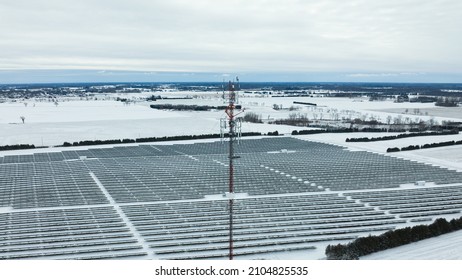 An Aerial, Level View Of The Top Of A Cell Tower In A Rural Area, Is Seen On A Snow-covered, Winter Day. 