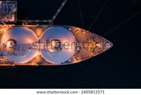 Aerial of Liquified Natural Gas LNG carrier moored to a small gas terminal. Fuel crisis. Sanctions. Top down view of a ship bow Stock foto © 
