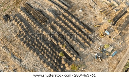Aerial of long parallel windrows of processed material at a solid waste recycling yard
