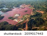 Aerial of a mine tailings reservoir in Magadascar, receiving slurry through a pipeline from an ore processing plant 