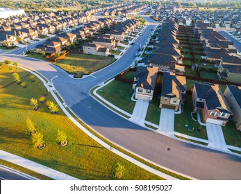 Aerial Morning Sun Over New Development Suburban Homes In North Austin Texas Low Angle With Long Perspective Over Neighborhood 