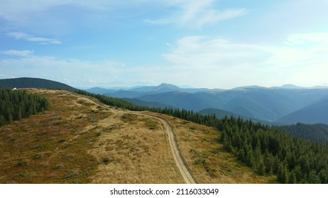 Aerial Mountain Path Scene With Stunning Rocky Pikes Background Against Sky. Tranquil Peaceful Drone View Hilly Road Travelling Natural Park Forest Location. Green Hills Woods Panorama Concept