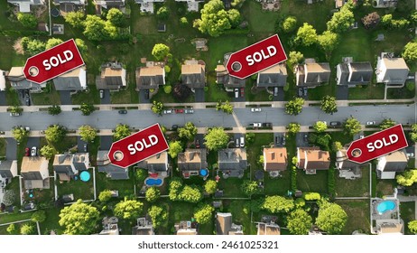 Aerial of a neighborhood with sold signs over several houses. Top down shot above modern American housing development with hot real estate market. 3D render - Powered by Shutterstock