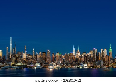 Aerial New York City Skyline From New Jersey Over The Hudson River With The Skyscrapers Of The Hudson Yards District At Night. Manhattan, Midtown, NYC, USA. A Vibrant Business Neighborhood