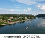 Aerial of the Niagara River and a boat at the village of Lewiston and the international border with Canada Queenston-Lewiston bridge in New York, United States, on a summer afternoon in July, 2024.