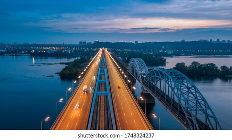 Aerial Night City View, Luminous Buildings And Bridge. Drone Shot.