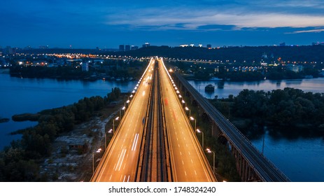 Aerial Night City View, Luminous Buildings And Bridge. Drone Shot.