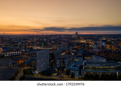 Aerial night time photo taken at sunset of  the area in Leeds known as The Leeds Dock showing the whole of the West Yorkshire city with the sun setting in the background