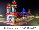 Aerial night view of meditating followers of the Cao Dai religion during Mid Autumn festival around Cao Dai temple in Tay Ninh city, Vietnam.Travel, festival and religion concept. Selective focus.