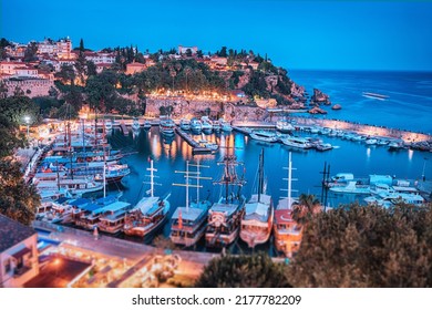 Aerial night view of the picturesque harbor with marina port with cruise tourist ships near the old town of Kaleici in Antalya. Turkish Riviera and travel in resort paradise - Powered by Shutterstock