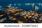 Aerial night view at world-class oil refinery, Petroleum refinery in the industrial factory of heavy industry zone, oil production plant, industrial process plant, oil storage tank.