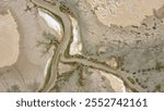 Aerial oblique image of salt flats with tidal river channel showing the contrast between wet and dry areas