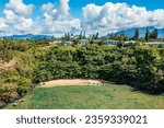 Aerial offshore view of the small sandy Sealodge beach in Princeville on the north coast of the hawaiian island of Kauai