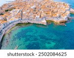 Aerial of Ortigia island, old town with turquoise sea of Syracuse. Small island on Sicily, Italy.