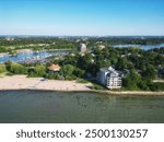 Aerial over Lakeside Park Beach in the Port Dalhousie area of St. Catharines, Ontario, Canada, on the south shore of Lake Ontario, with Martindale Pond. Shot on a summer afternoon in July, 2024.