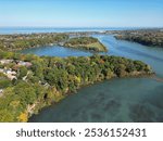 Aerial over Martindale Pond viewing north towards Henley Island, Port Dalhousie and Lake Ontario in St. Catharines, Ontario, Canada on a sunny Autumn day in October, 2024.