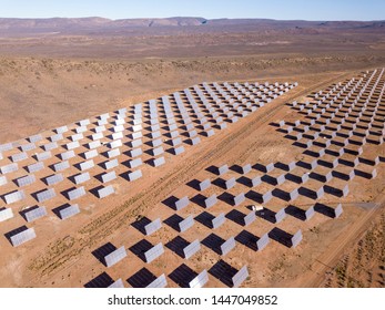 Aerial over solar panels in a dry landscape - Shutterstock ID 1447049852