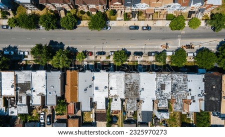 aerial overhead drone view of a Chicago urban neighborhood during the afternoon .  the residential area is has colorful buildings great for a background
